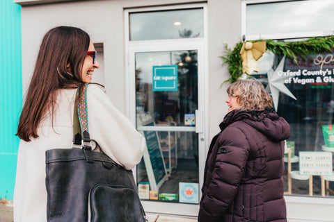 Two women standing in front of Fair/Square, about to go shopping